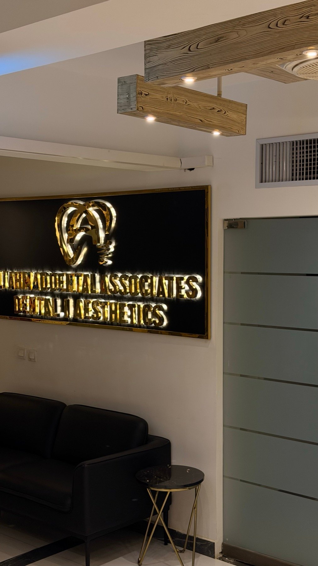 Reception with the Ali Ahmad Dental & Aesthetics logo wall